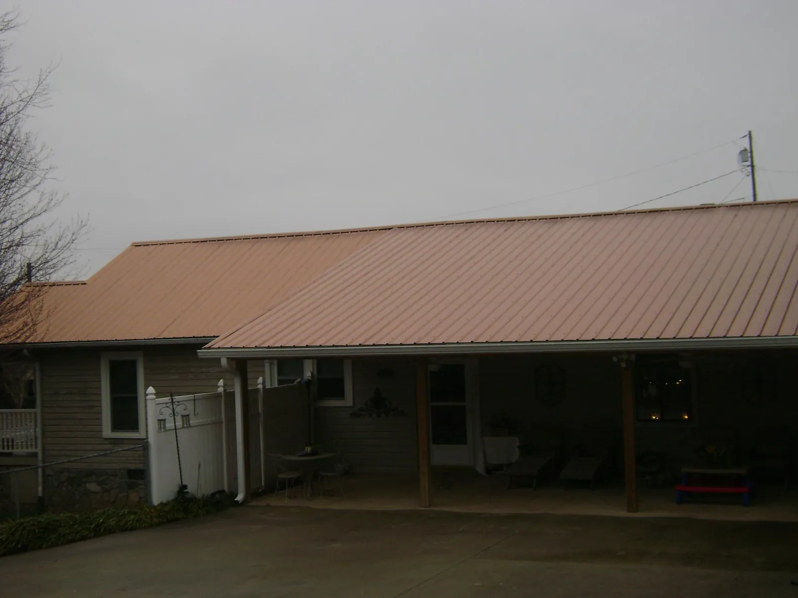 Copper toned metal roof over a wide covered patio in Columbia